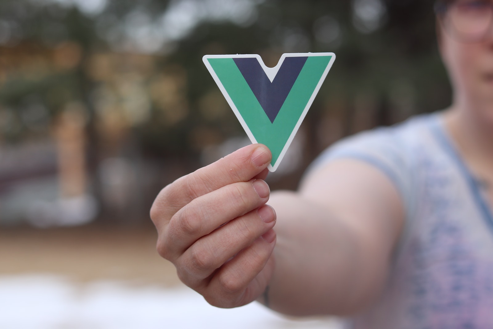 Person Holding Vuejs logo