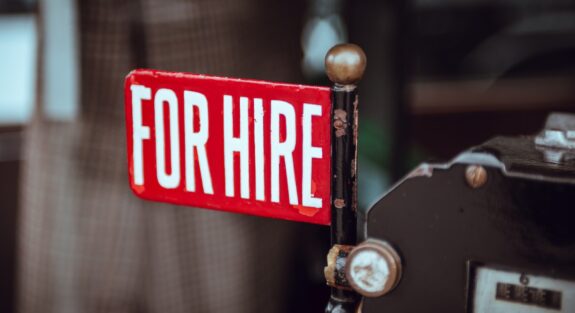 shallow focus photography of red and white for hire signage